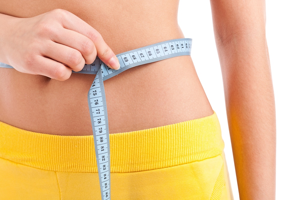 lose weight - lady with measuring tape around waist