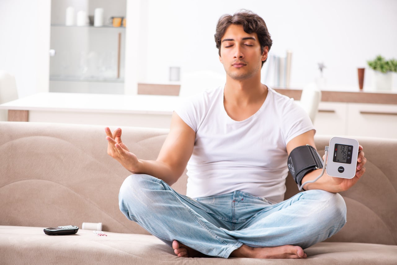 Man praciticing yoga for high blood pressure management